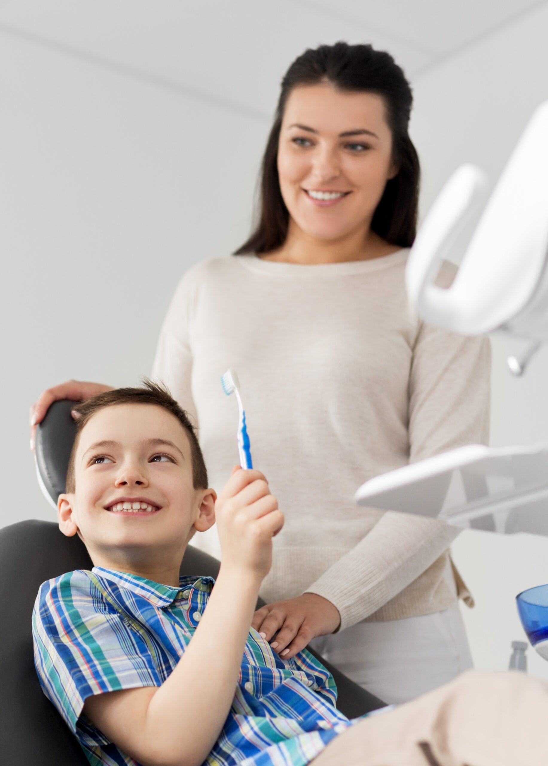 mother and son visiting dentist at dental clinic