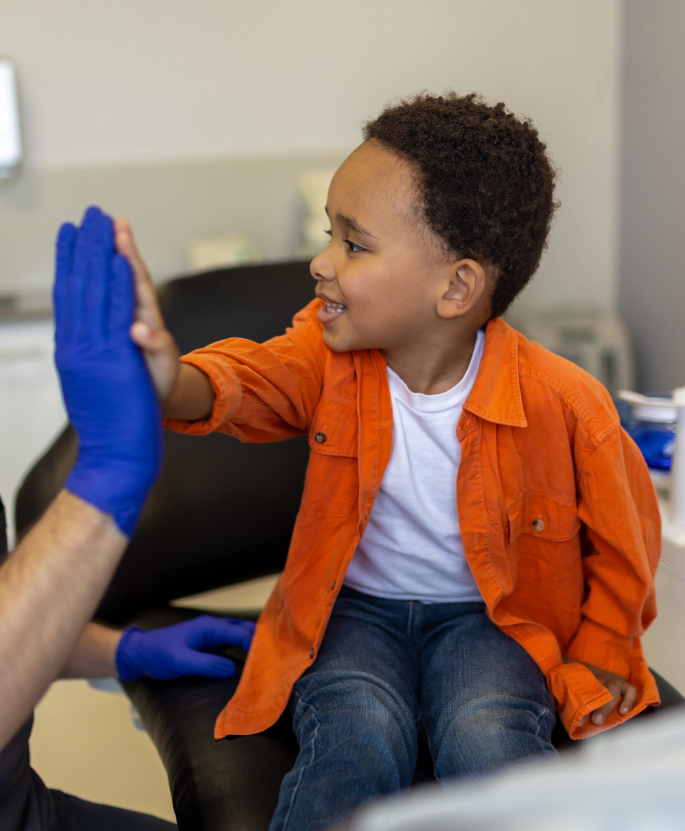 High five. Doctor and little patient doing high five and looking contented