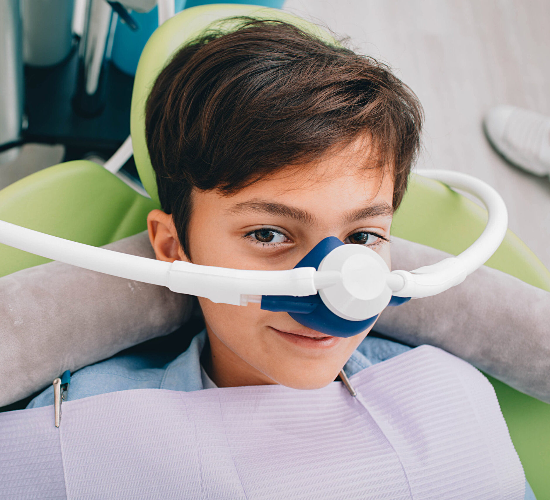 Little boy getting Inhalation Sedation while teeth treatment at dental clinic. Teeth treatment child