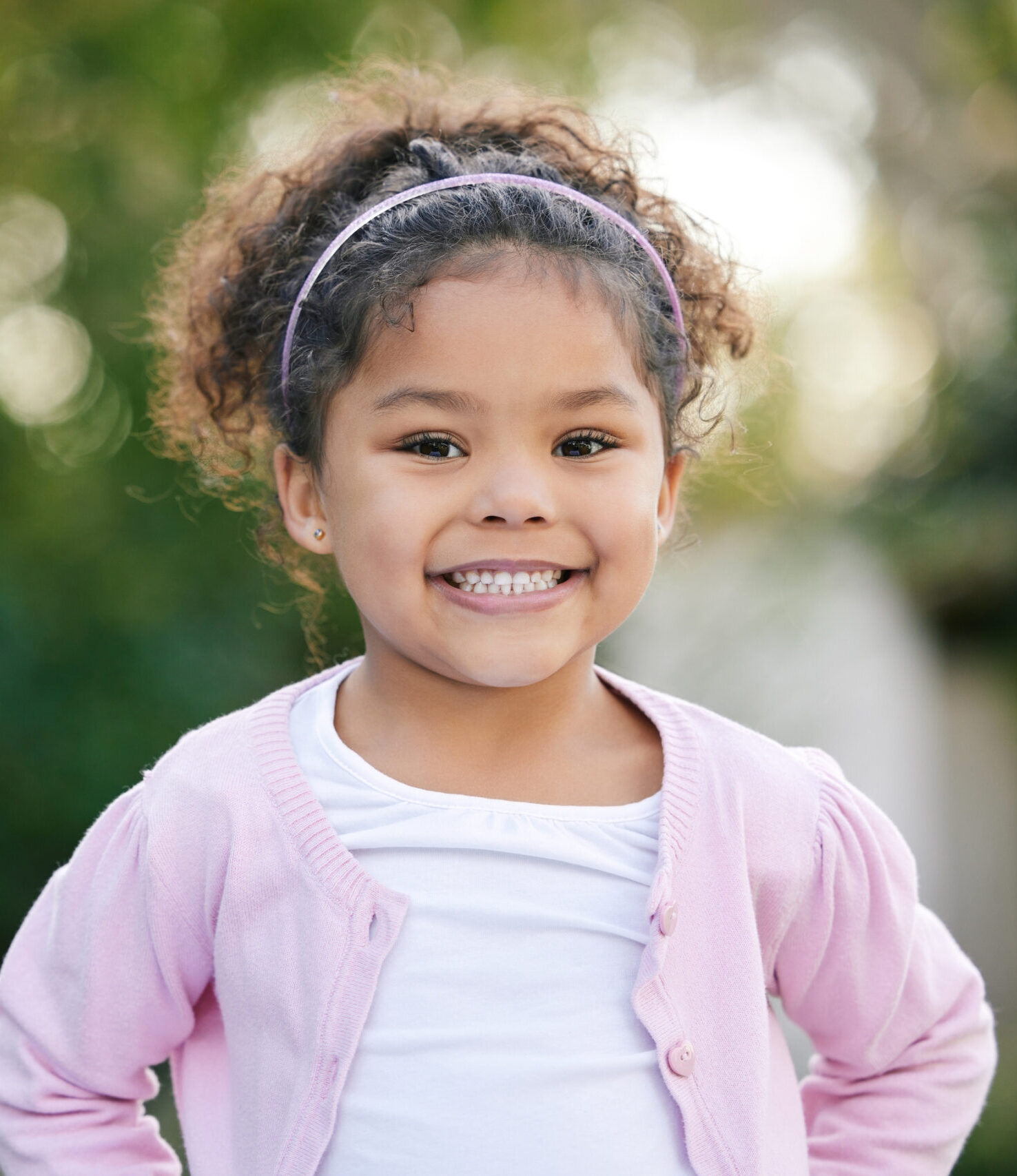 Happy, smile and portrait of a kid in a garden with joy, positive emotion and childhood growth. Happiness, excited girl and face of cute child from Mexico standing outdoor in park with mockup space.